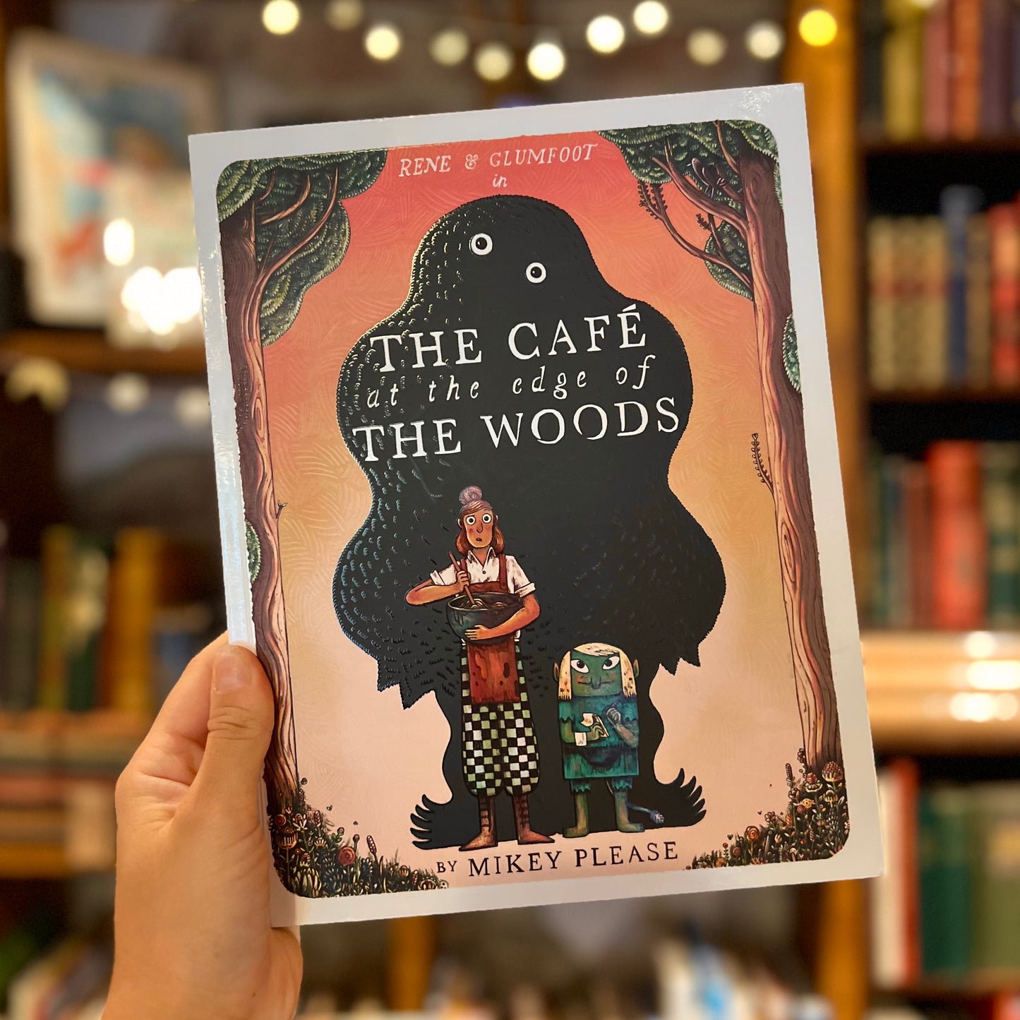 The Café at the Edge of the Woods – Mikey Please